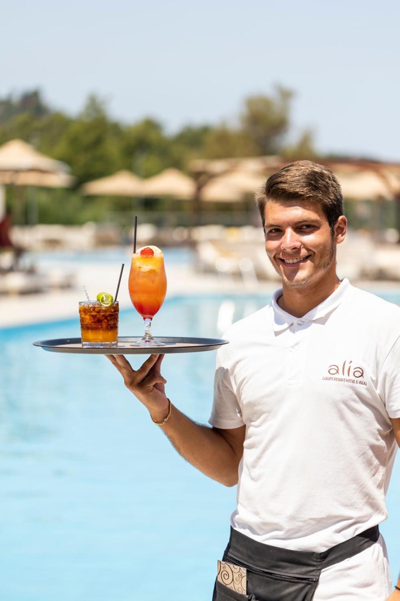 Alia Palace Hotel - Adults Only 16+ Chalkidiki Ngoại thất bức ảnh A waiter serving drinks