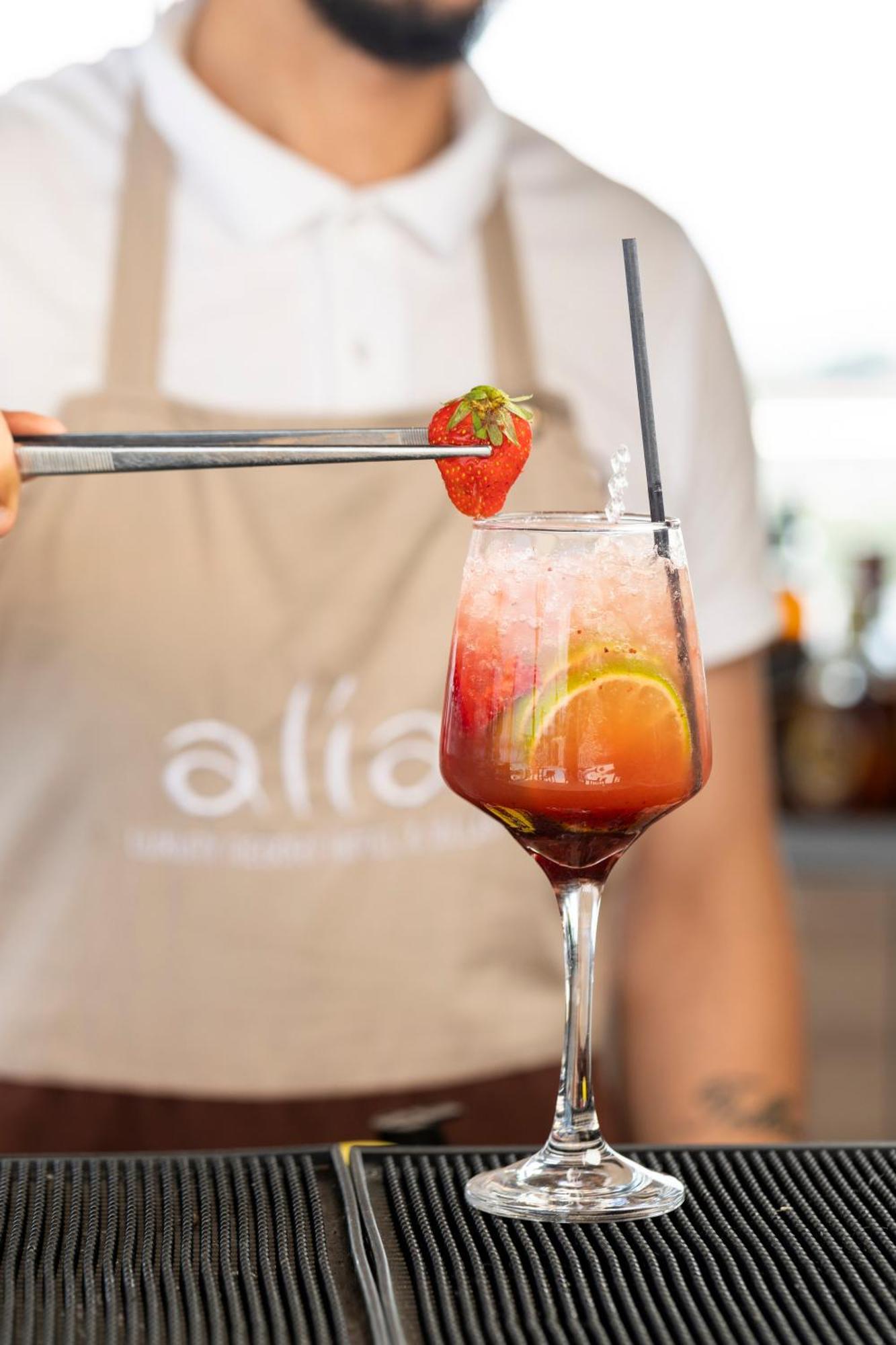 Alia Palace Hotel - Adults Only 16+ Chalkidiki Ngoại thất bức ảnh A strawberry being placed on a strawberry bellini